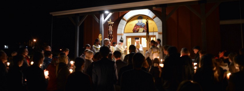 The faithful gather at the door of the church.